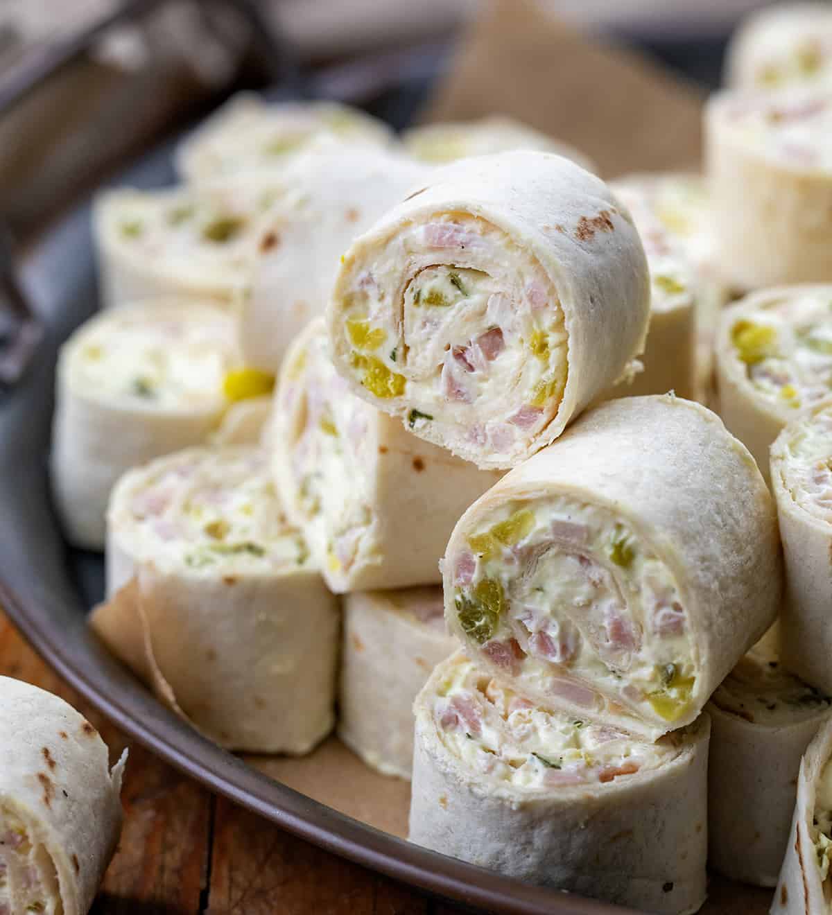 Close up of Ham and Pickle Pinwheels on a platter.