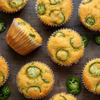 Jalapeno Cheddar Cornbread Muffins on a wooden table from overhead.