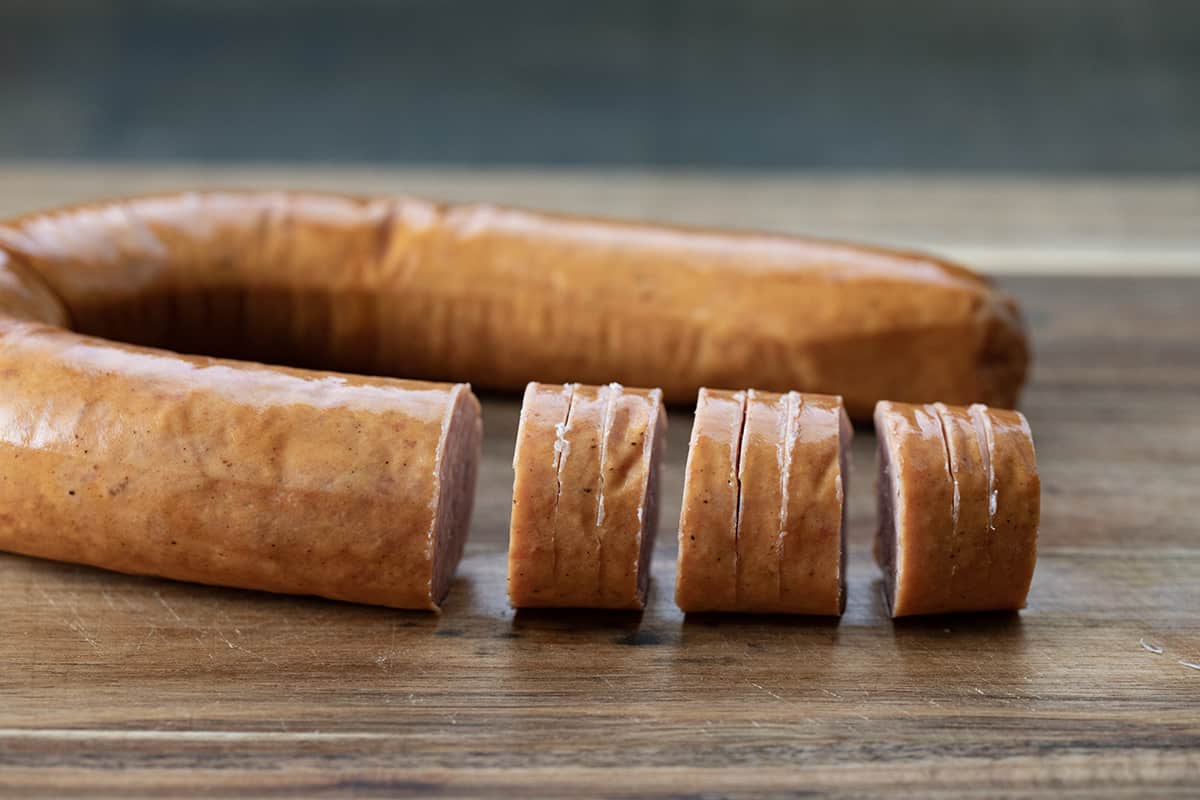 Cutting up Kielbasa for hasselback bites.