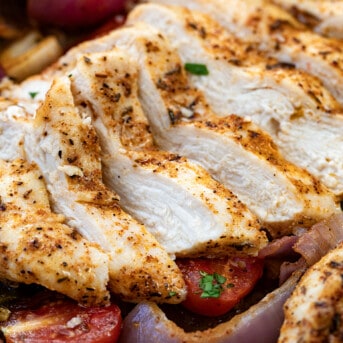 Sliced Sheet Pan Roasted Salsa Chicken very close up showing some vegetables.