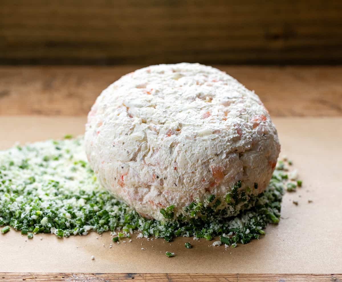 Rolling shrimp cheese ball in chives.