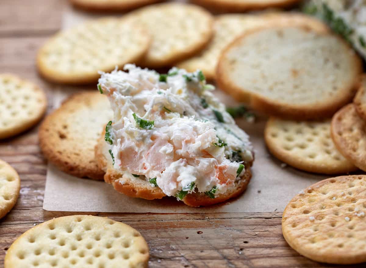 Cracker with shrimp cheese dip on it.