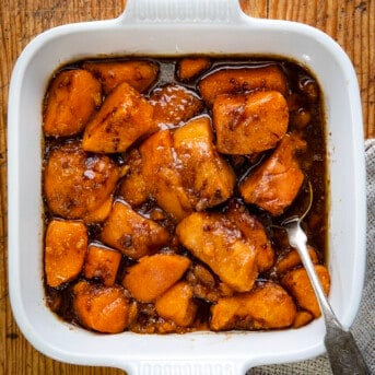 Pan of Easy Candied Yams on a table from overhead with a spoon.