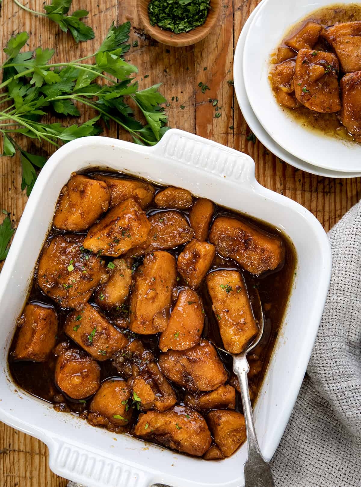 Pan of Easy Candied Yams on a table with a spoon in the pan.