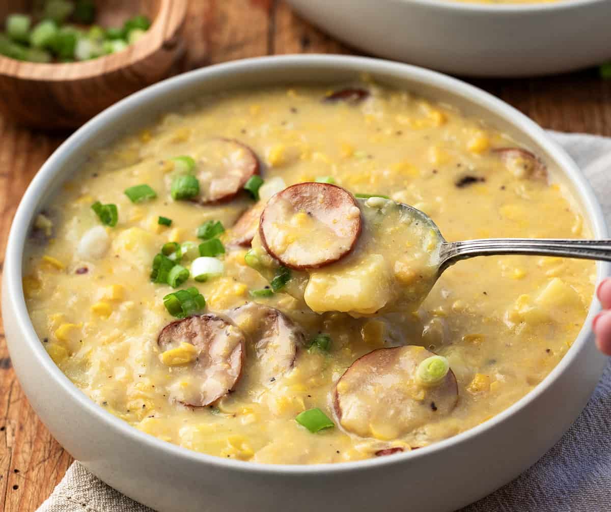 Spoonful of Andouille Corn Chowder over a bowl.