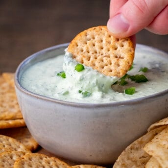 Dipping a chip into Creamy Jalapeno Dip.