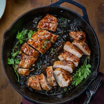 Pork Tenderloin With Apricot Glaze in a skillet cut into slices.