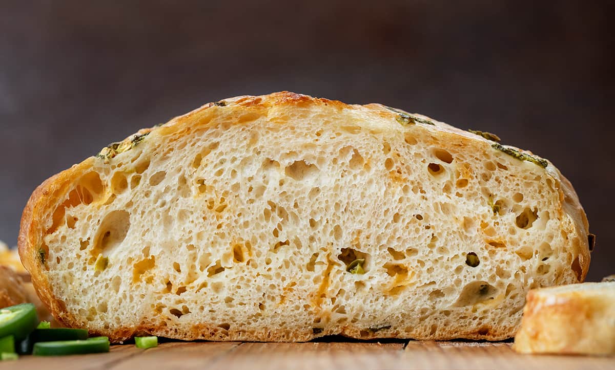 Loaf of Jalapeno Cheddar Bread Sliced in half showing inside.