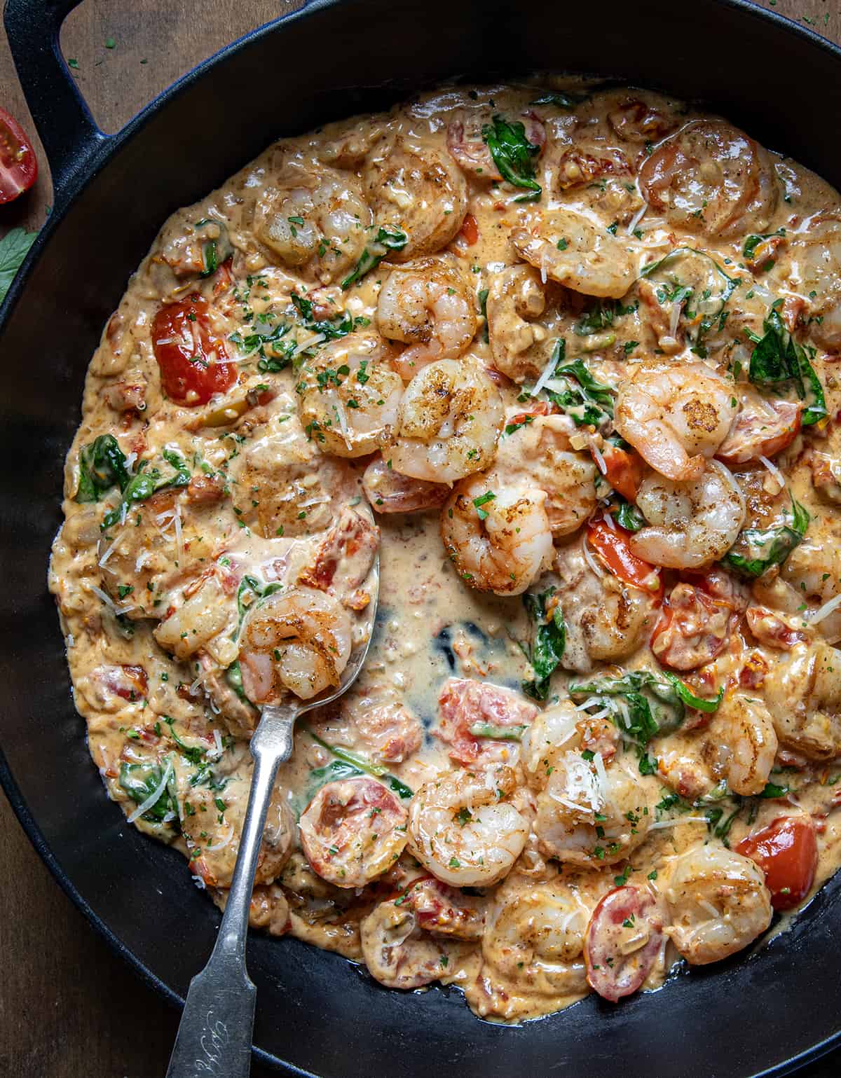 Pan of Creamy Tuscan Shrimp with a spoon in the sauce.