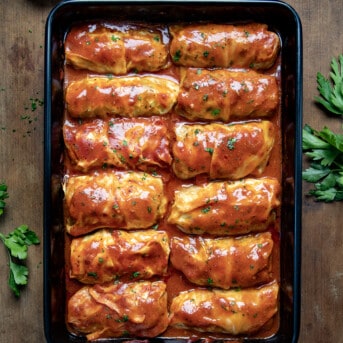 Pan of Cabbage Rolls on a wooden table from overhead.