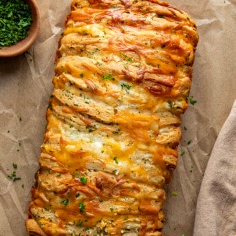 Cheesy Garlic Pull-Apart Bread on a wooden table from overhead.