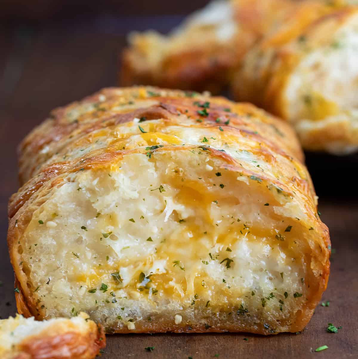 Close up of the inside Cheesy Garlic Pull-Apart Bread with some pieces removed.