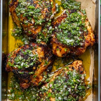 Tray of Chimichurri Chicken on a wooden table from overhead.