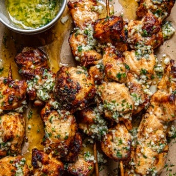 Close up of Garlic Parmesan Chicken Skewers coated in sauce from overhead.