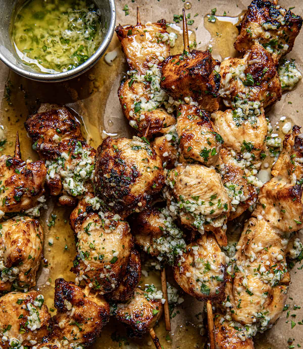 Close up of Garlic Parmesan Chicken Skewers coated in sauce from overhead.