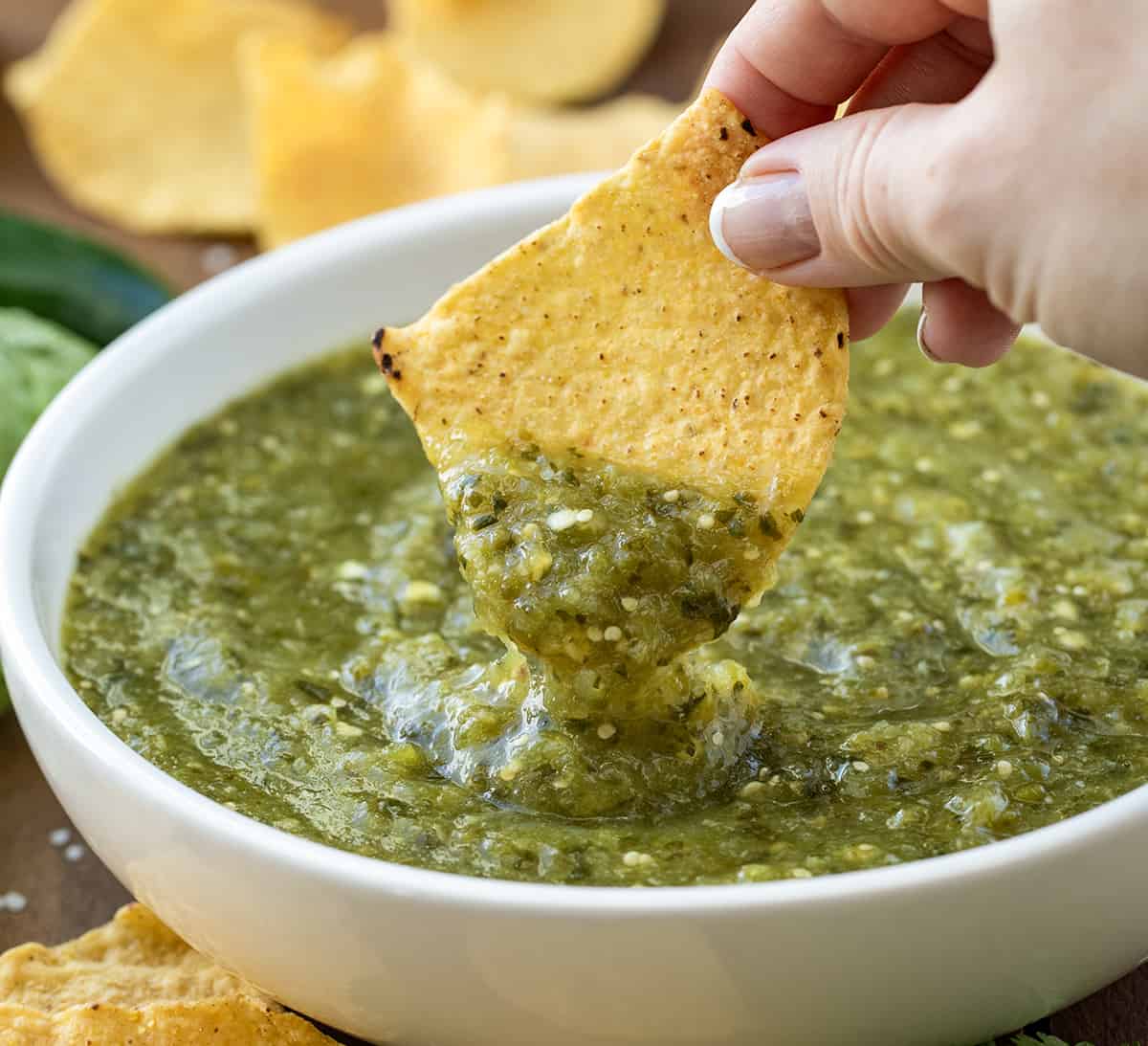 Dipping a chip into Salsa Verde.