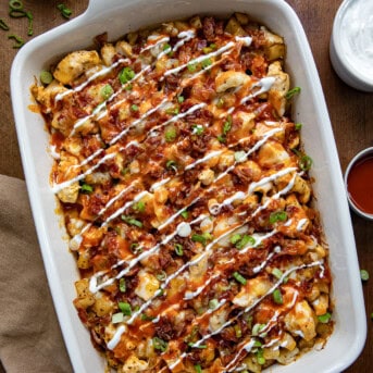 Buffalo Chicken Roasted Potato Bake in a casserole pan on a wooden table from overhead.