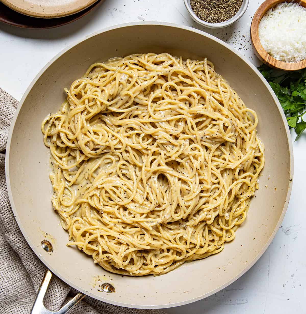 Cacio e Pepe in a skillet on a table from overhead.