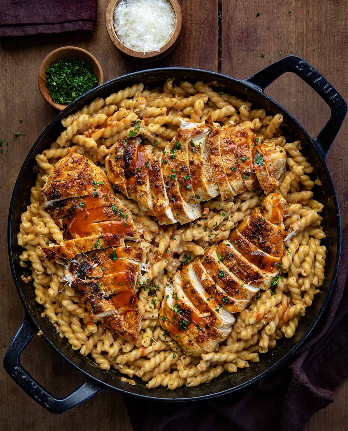 Skillet of Creamy Buffalo Chicken Pasta on a wooden table from overhead. 