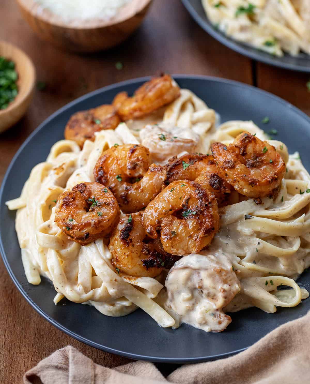 Plate of Shrimp Alfredo on a wooden table.