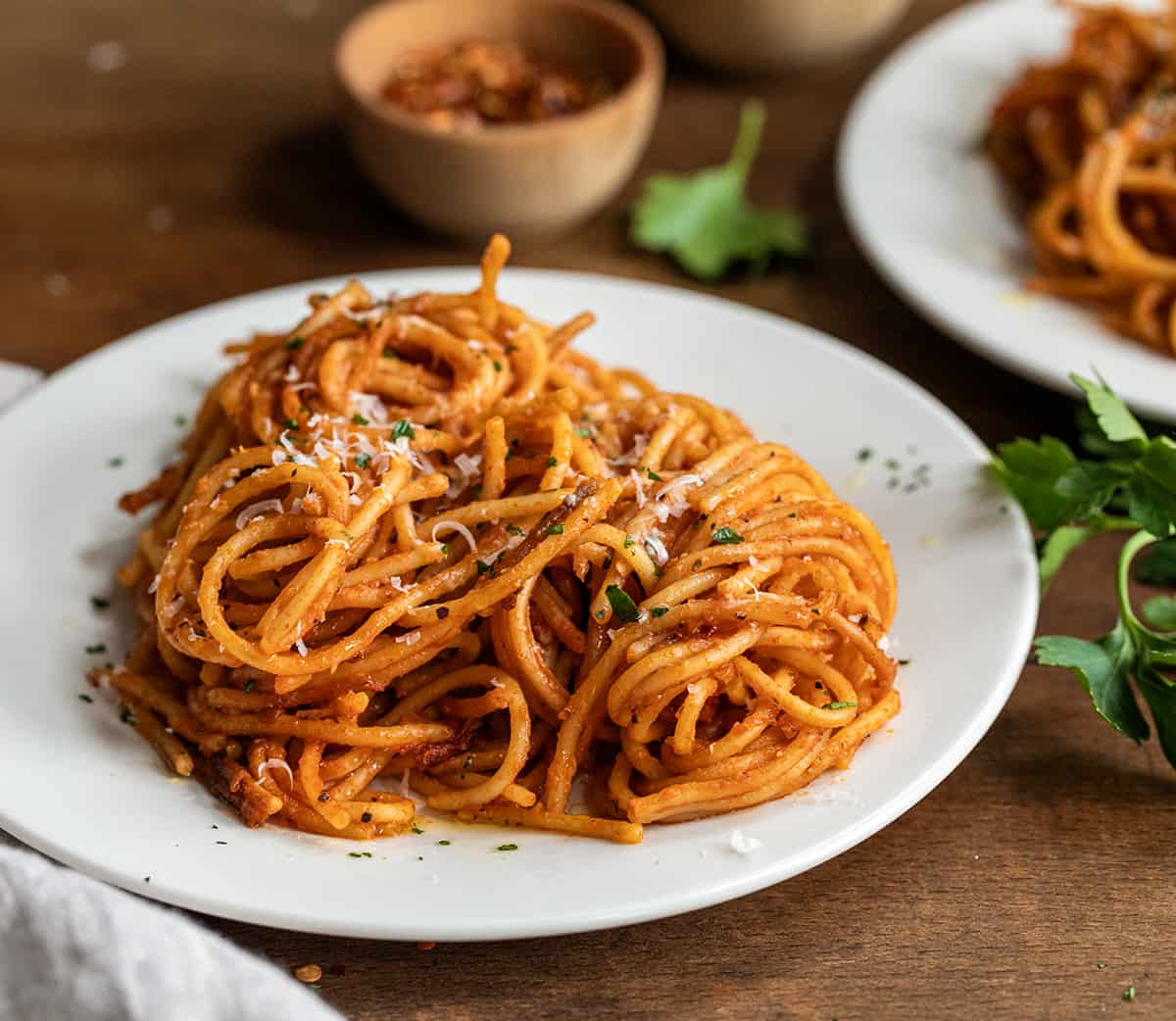 Plate of Assassin Spaghetti on wooden table.