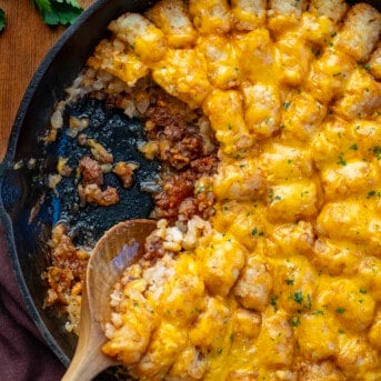 Sloppy Joe Tater Tot Casserole in a skillet with some removed so the sloppy joe is showing.