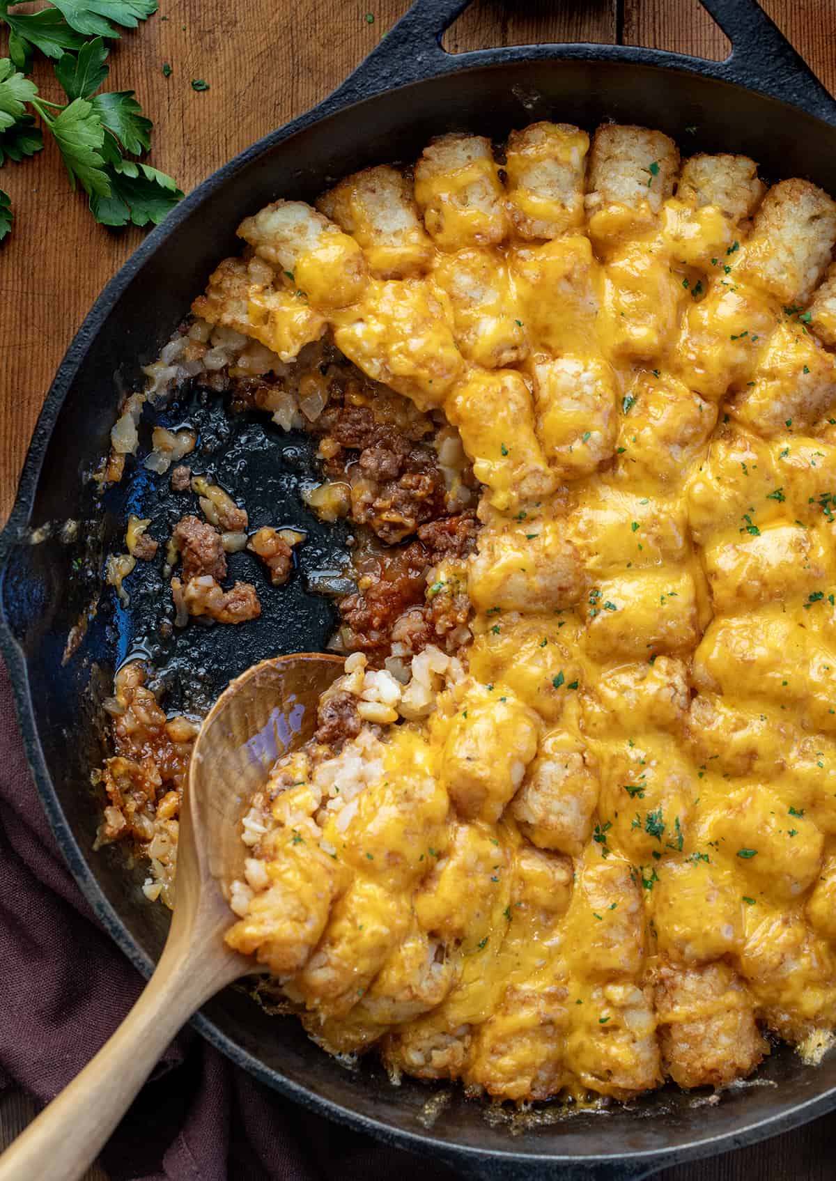 Sloppy Joe Tater Tot Casserole in a skillet with some removed so the sloppy joe is showing.