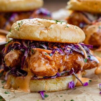 Bang Bang Chicken Sandwich with crispy chicken covered in Bang Bang Sauce and topped with slaw close up.