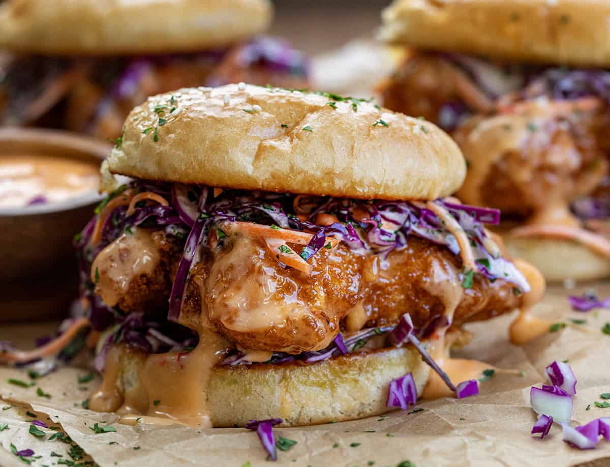 Bang Bang Chicken Sandwich with crispy chicken covered in Bang Bang Sauce and topped with slaw close up.