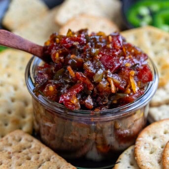 Jar of Jalapeno Bacon Jam surrounded by crackers.