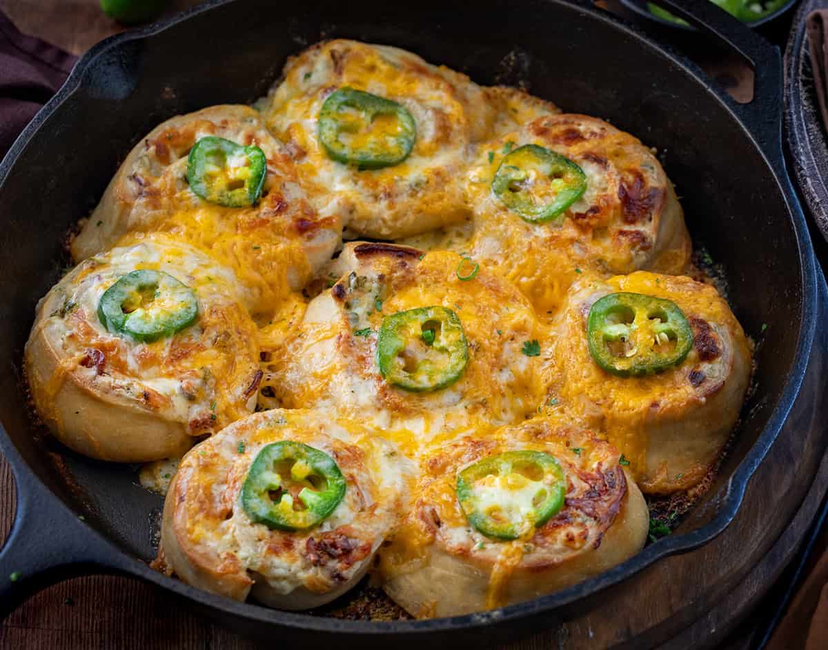 Skillet Jalapeno Popper Rolls on a wooden table.