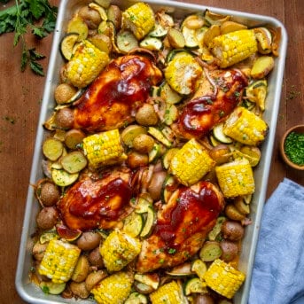 BBQ Chicken Sheet Pan Meal on a wooden table from overhead.