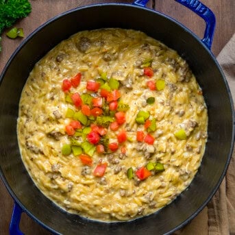 Pot of Cheeseburger Orzo on a wooden table from overhead.