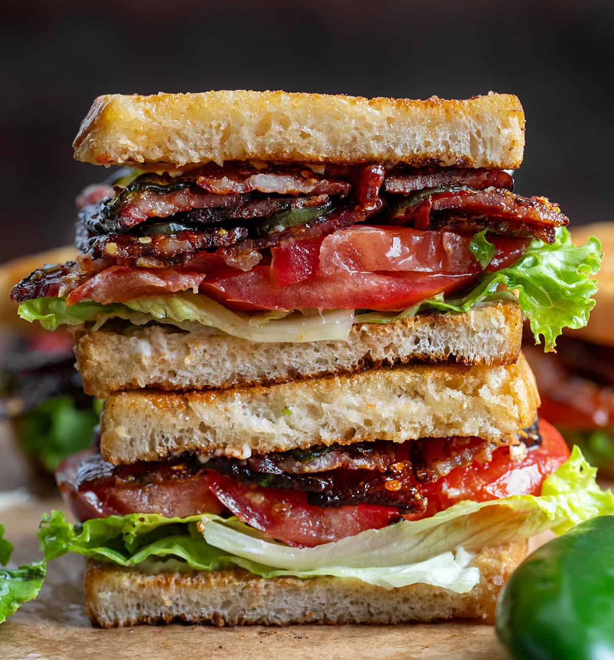 Spicy Candied Bacon BLT cut in half and stacked on top of each other. 