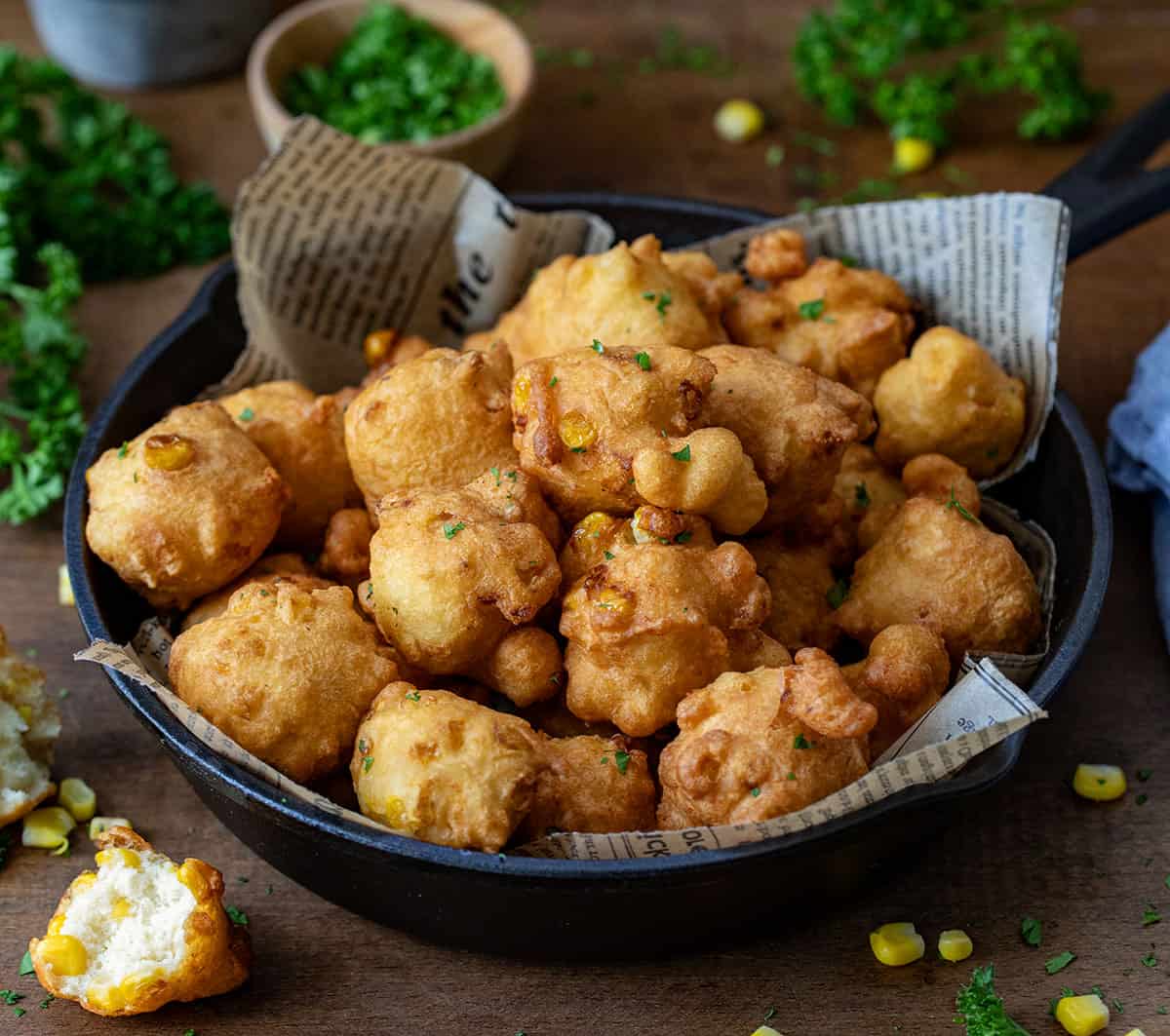 Skillet of Corn Nuggets on a wooden table.