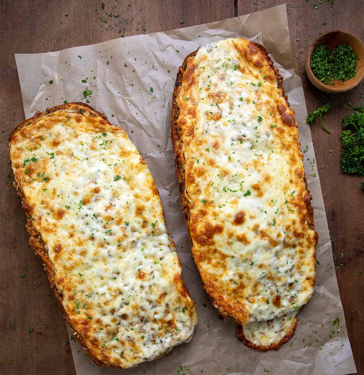 Cowboy Butter Garlic Bread on a wooden table from overhead. 