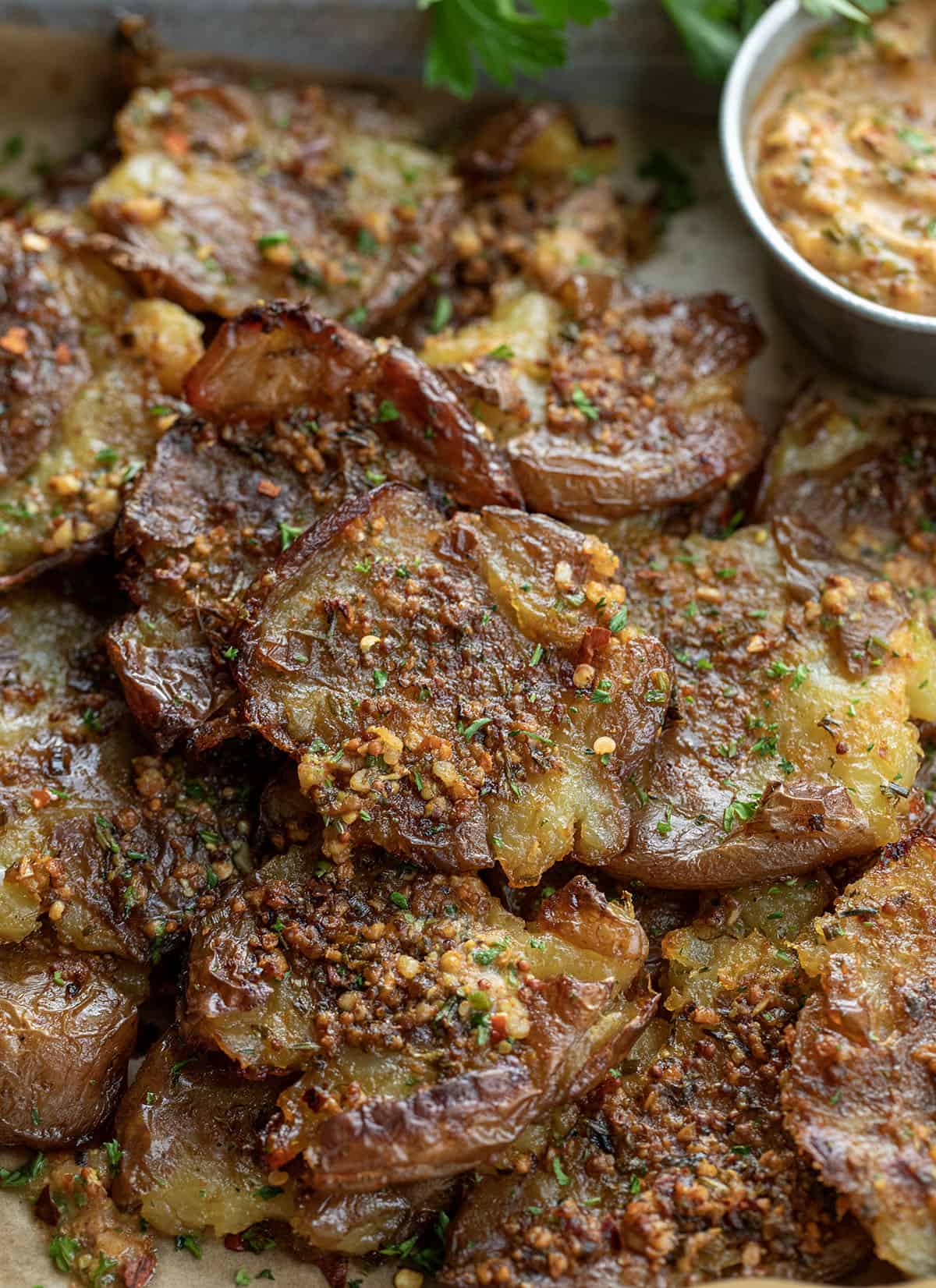 Close up of smashed potatoes seasoned with cowboy butter.