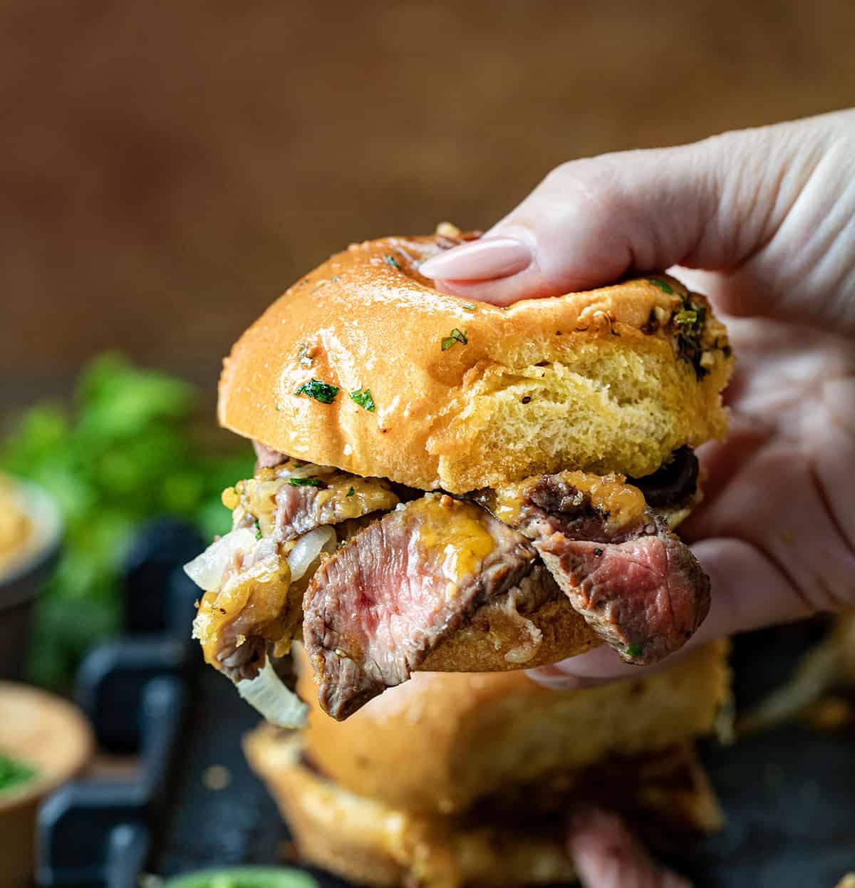 Hand holding a Cowboy Steak Slider.