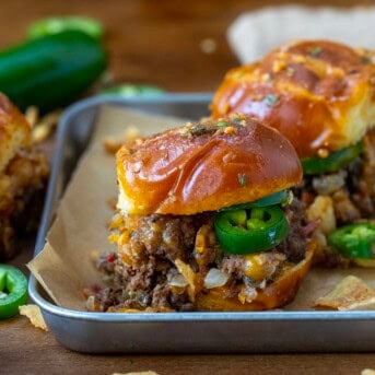 Pretzel Cowboy Sliders in a tray on a wooden table.