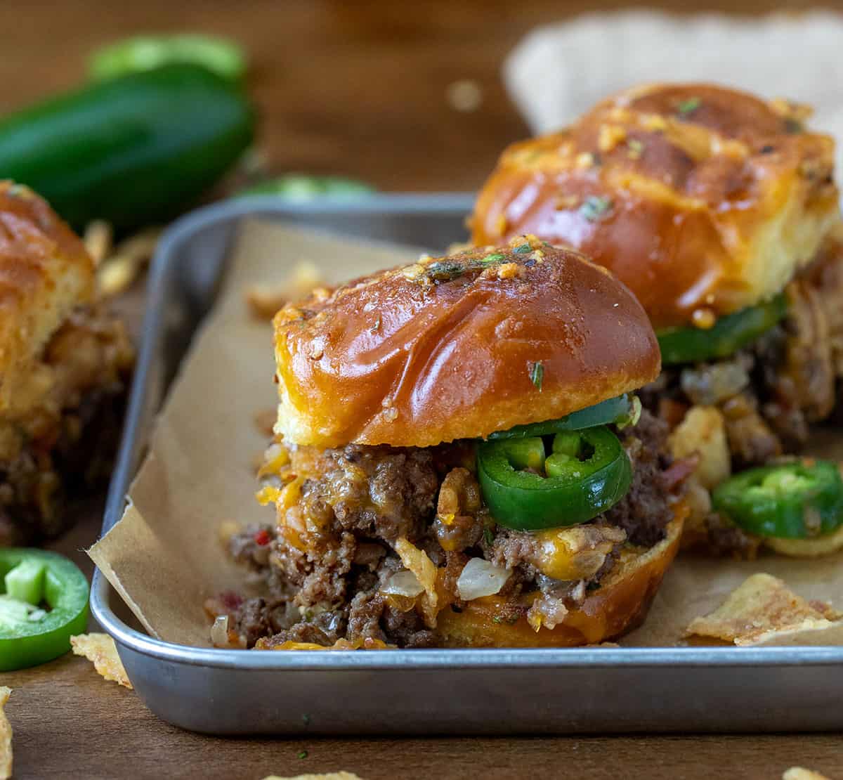 Pretzel Cowboy Sliders in a tray on a wooden table. 