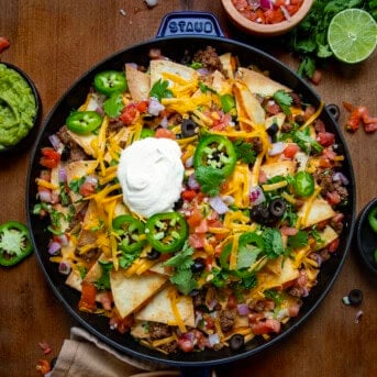 Pan of Quesadilla Nachos on a wooden table from overhead.
