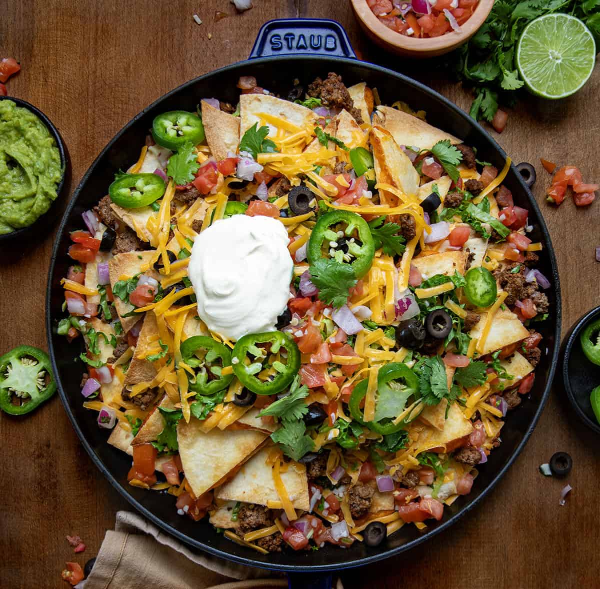 Pan of Quesadilla Nachos on a wooden table from overhead.