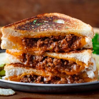 Stacks of cut into Sloppy Joe Grilled Cheese Sandwiches.