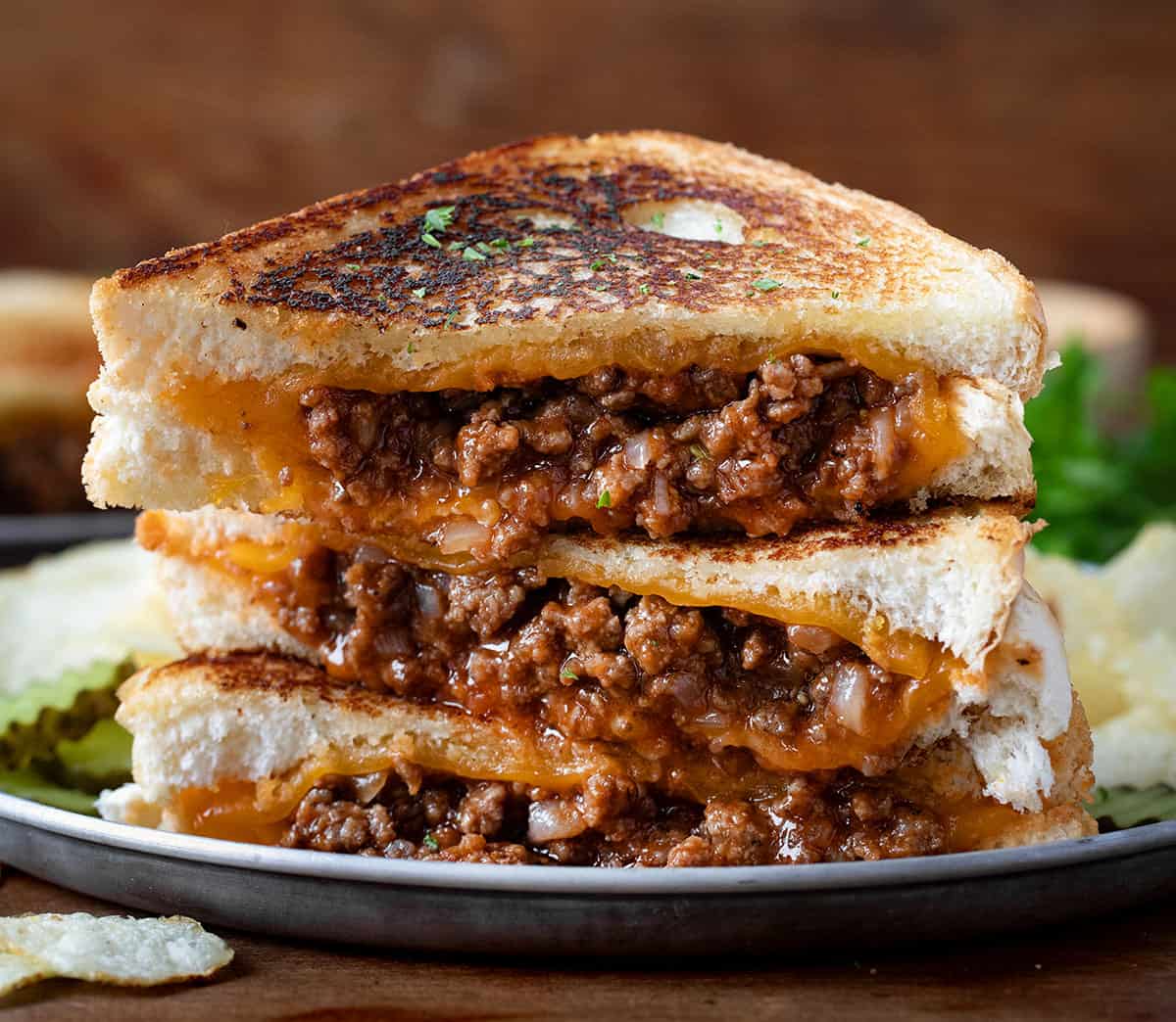 Stacks of cut into Sloppy Joe Grilled Cheese Sandwiches.