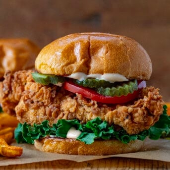 Spicy Chicken Sandwich on a wooden table very close up showing the crispy chicken.