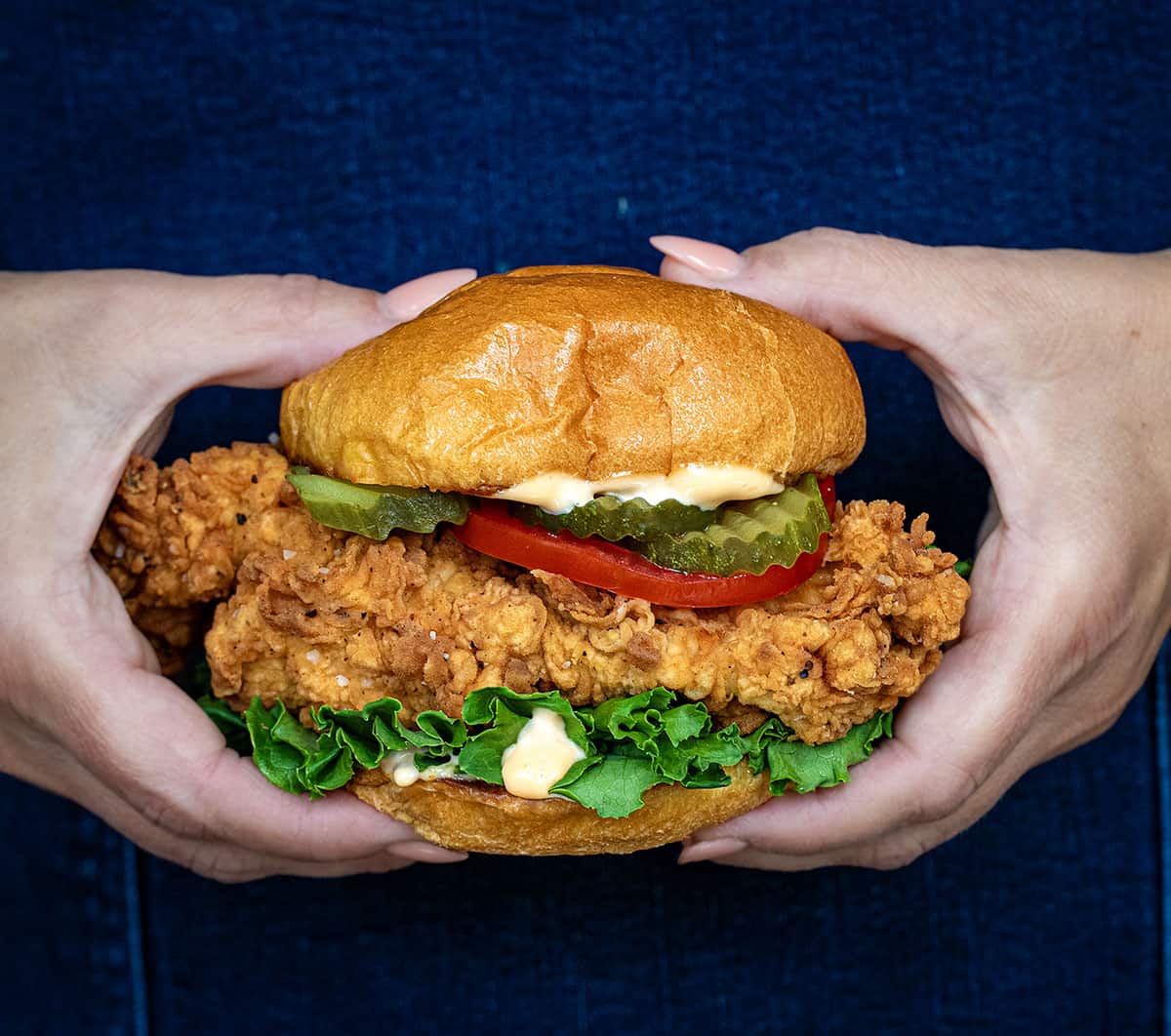 Hands holding a Spicy Chicken Sandwich.