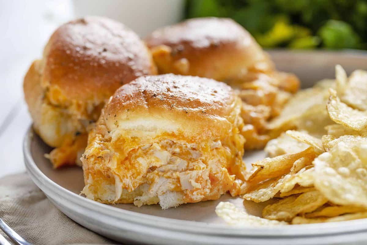 plate of 3 buffalo chicken sliders with chips