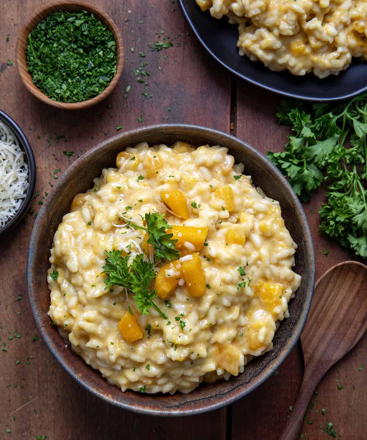 Bowls of Butternut Squash Risotto on a wooden table from overhead.