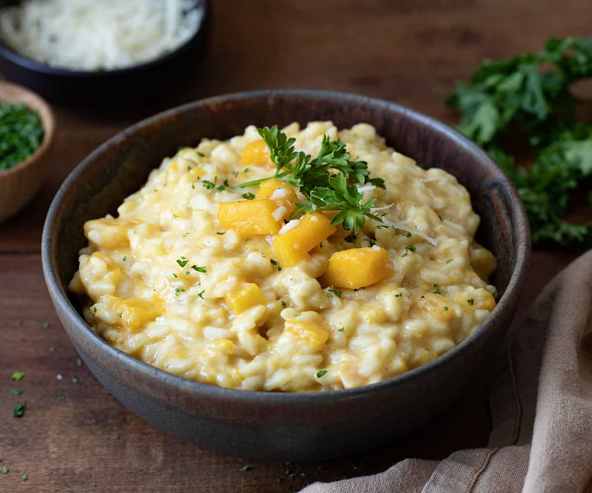 Bowl of Butternut Squash Risotto on a wooden table.