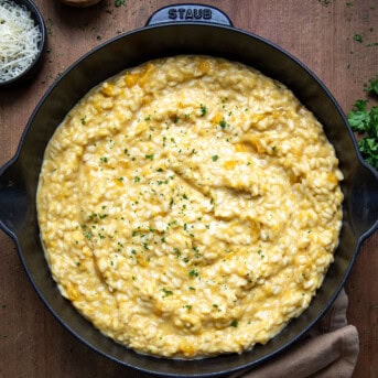 Skillet of Butternut Squash Risotto on a wooden table from overhead.